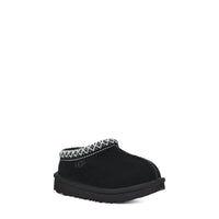 Black slipper with decorative trim on a white background