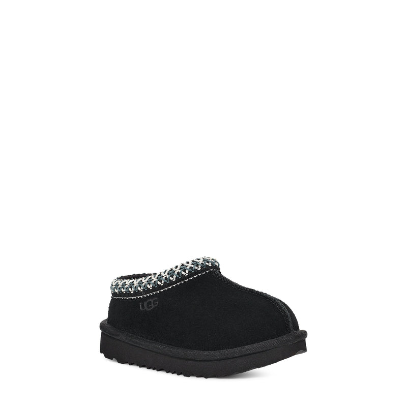 Black slipper with decorative trim on a white background