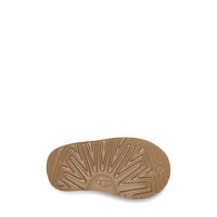 Brown sole of a shoe with 'UGG' branding on a white background