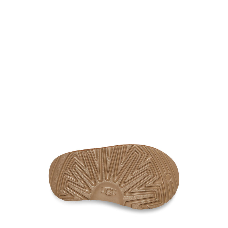 Brown sole of a shoe with 'UGG' branding on a white background