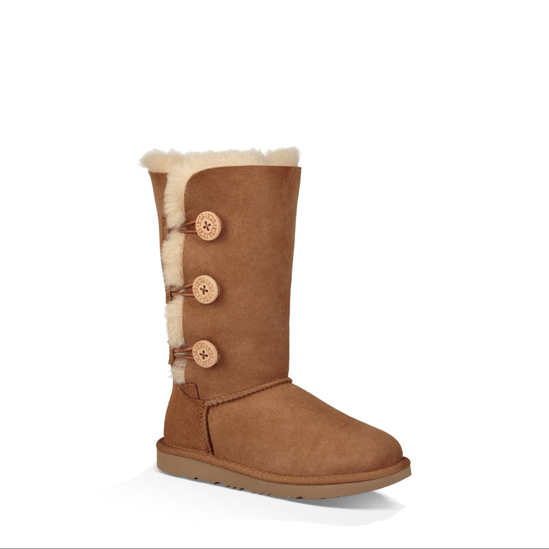 Brown boot with beige fur lining and buttons on a white background