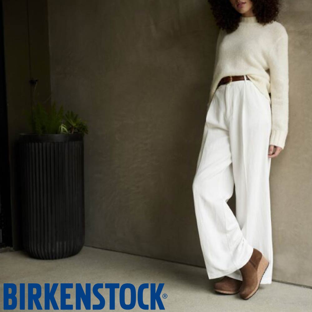 birkenstock lifestyle image woman dressed in white with suede boots
